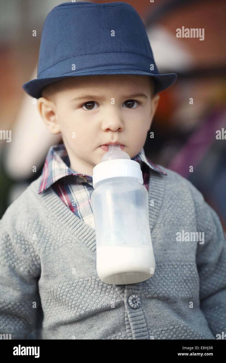 little boy with bottle in mouth Stock Photo Alamy