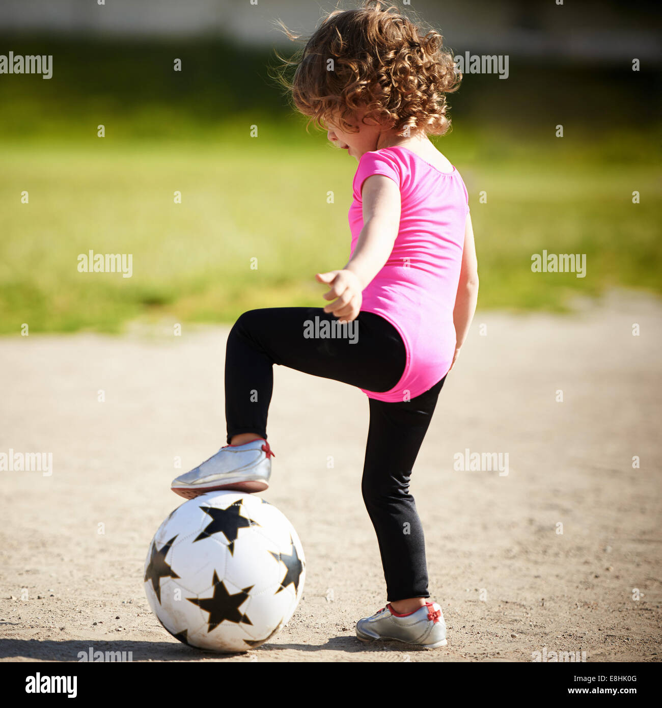 cute little girl plays football Stock Photo - Alamy