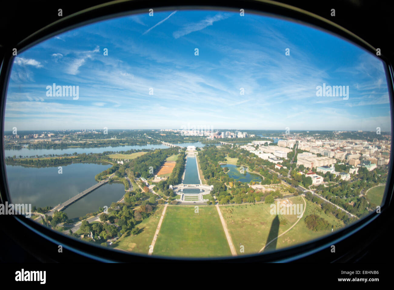 WASHINGTON DC, USA - The view from one of the windows at the top of the Washington Monument, looking out over the Reflecting Pool and the Lincoln Memorial towards Arlington Memorial Bridge and Arlington, VA. The Washington Monument stands at over 555 feet (169 metres) at the center of the National Mall in Washington DC. It was completed in 1884 and underwent extensive renovations in 2012-13 after an earthquake damaged some of the structure. Stock Photo