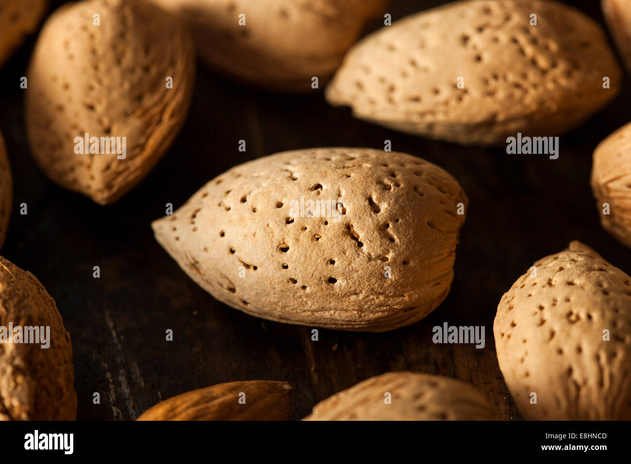 Raw Unshelled Organic Almonds on a Background Stock Photo