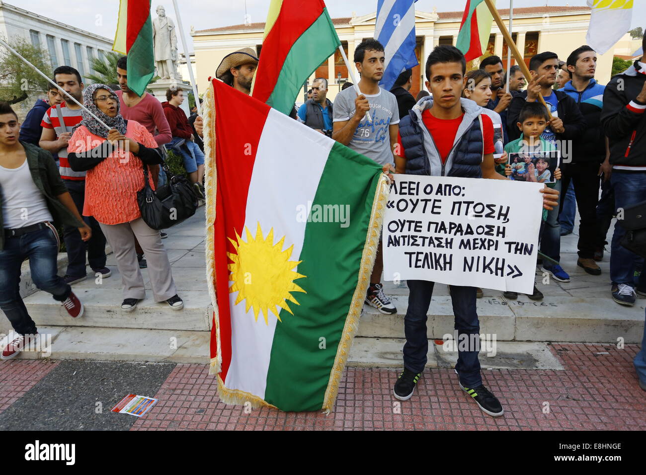 Athens, Greece. 8th October 2014. A protester holds a Kurdish flag and calls for support for Kobane. Kurds living in Greece protested against the attacks of the Islamic State (IS) on the city of Kobane in Syria, calling for international support of the Kurdish fighters. They also protested against the alleged support of IS by the Turkish state. Credit:  Michael Debets/Alamy Live News Stock Photo