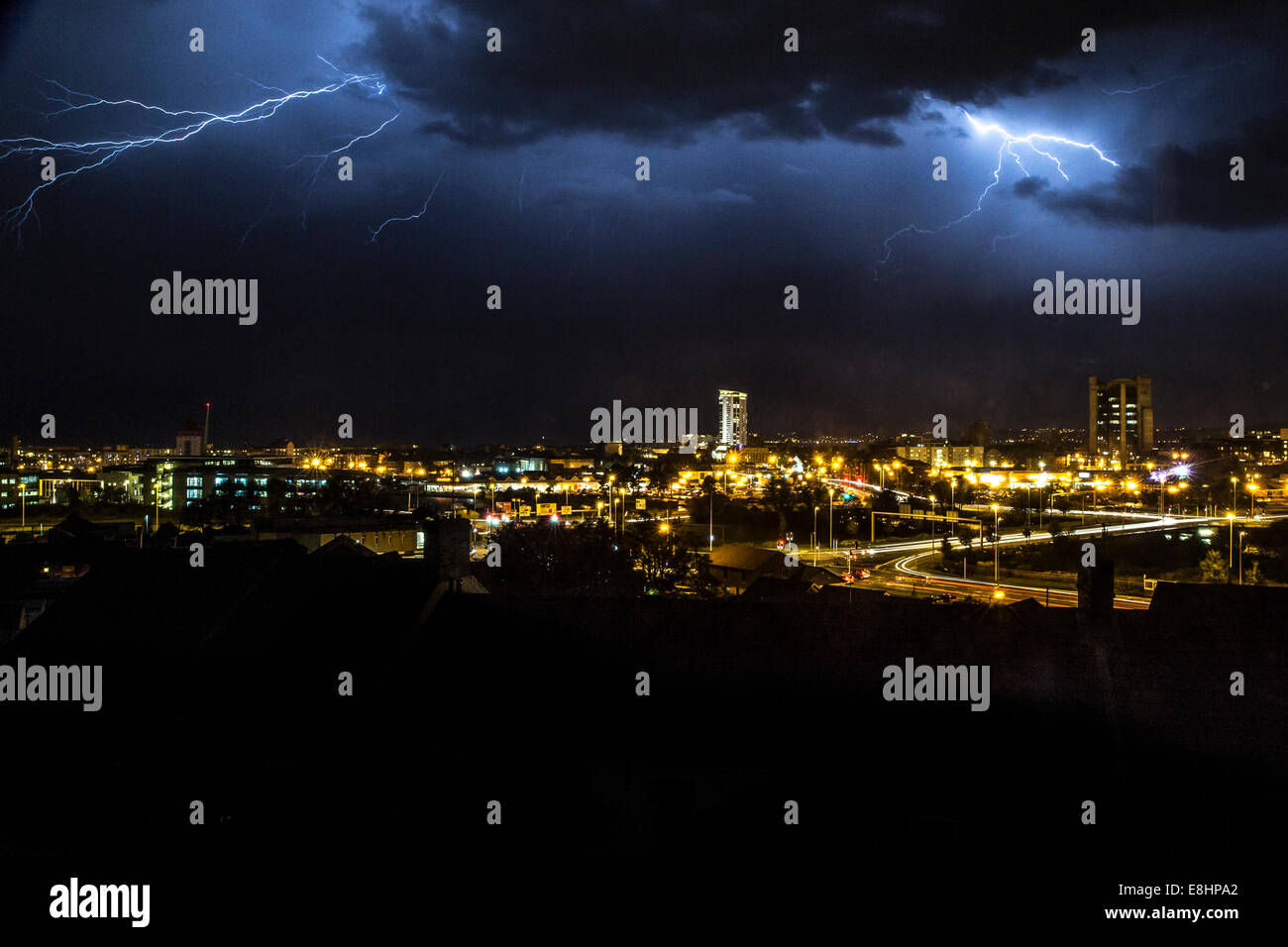 Electrical storm over Swansea Bay, fork lightning display at night over Swansea city centre Stock Photo