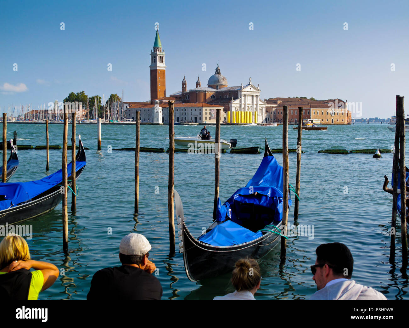 Traditional Venetian gondolas in Bacino di San Marco with San Giorgio Maggiore visible across the water in Venice Northern Italy Stock Photo