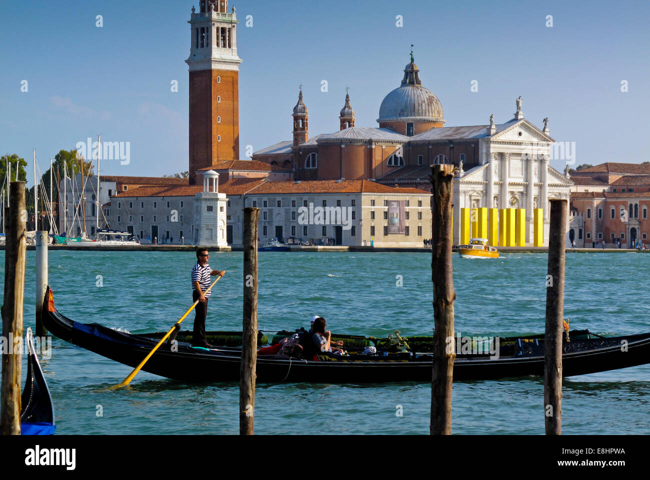 Traditional Venetian gondolas in Bacino di San Marco with San Giorgio Maggiore visible across the water in Venice Northern Italy Stock Photo