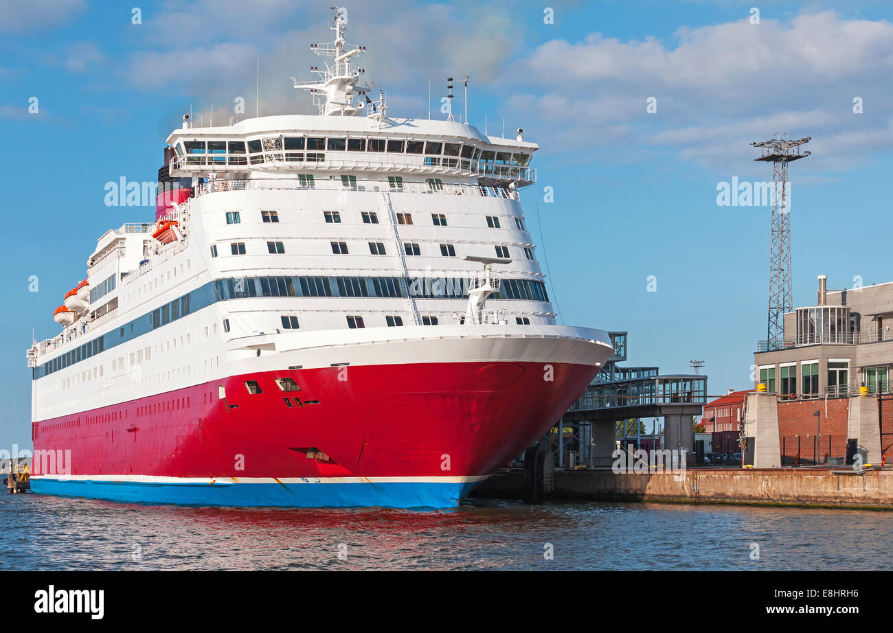 Red and white passenger ferry is moored in port Stock Photo