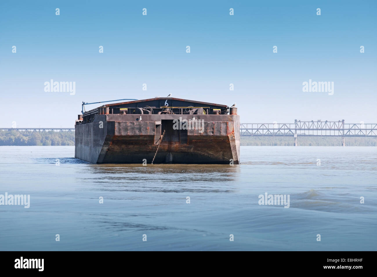 Black cargo barge is anchored on the still Danube river Stock Photo