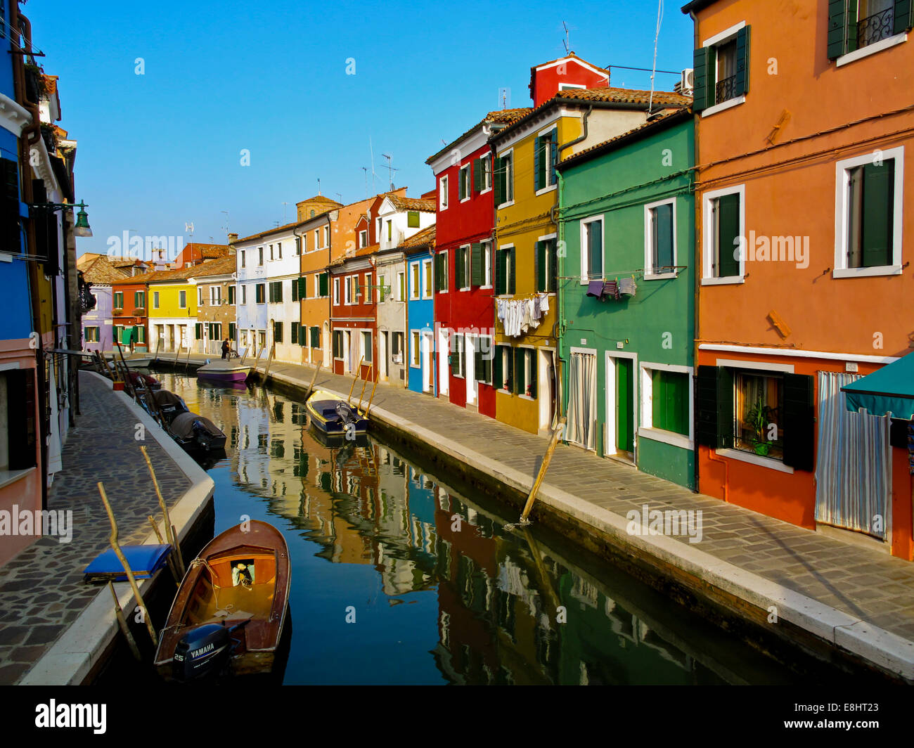 Traditional houses next to a canal in Murano an island in the Lagoon at Venice or Laguna Veneto northern Italy Stock Photo