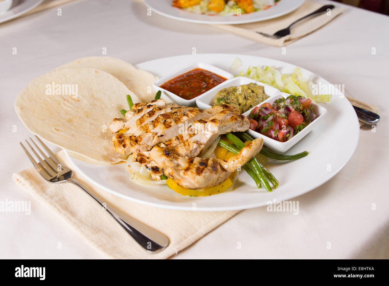 Grilled Chicken Fajitas on Plate at Place Setting in Restaurant Stock Photo  - Alamy