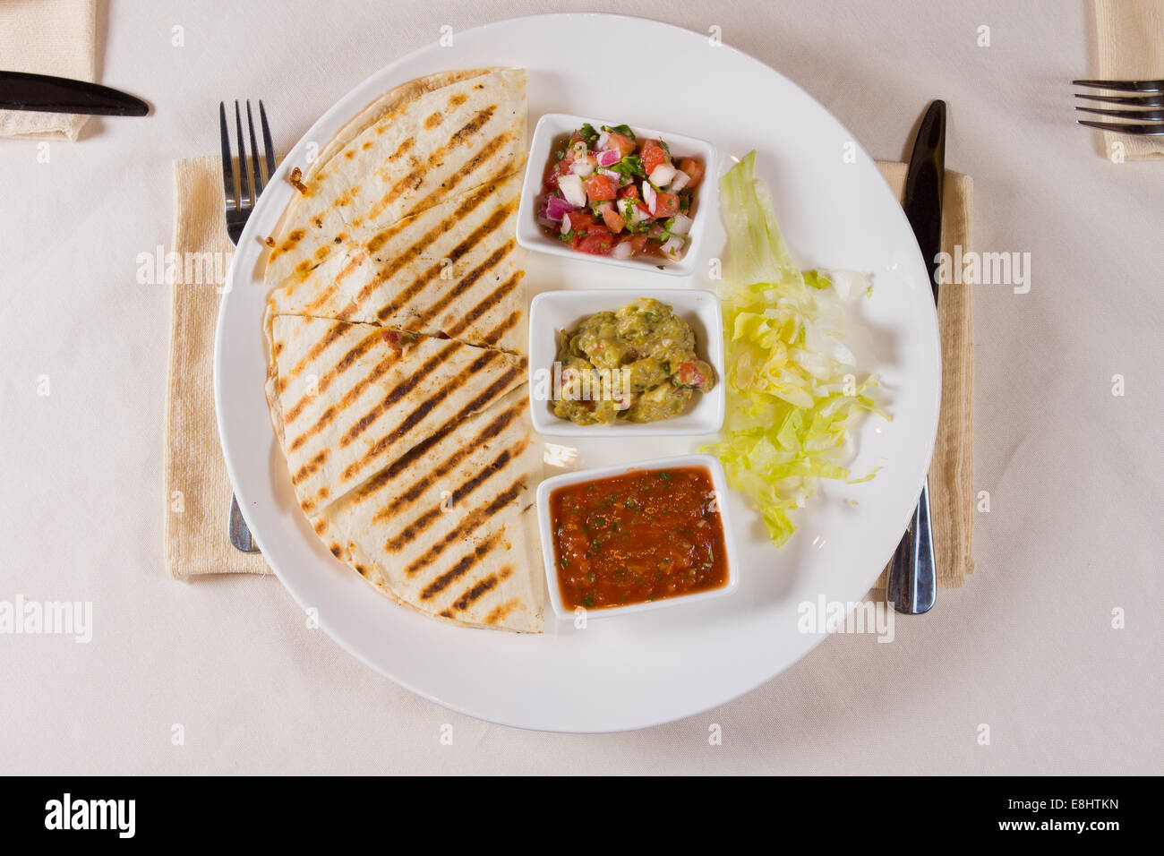 Overhead of Grilled Quesadilla on Plate with Variety of Salsas Stock Photo