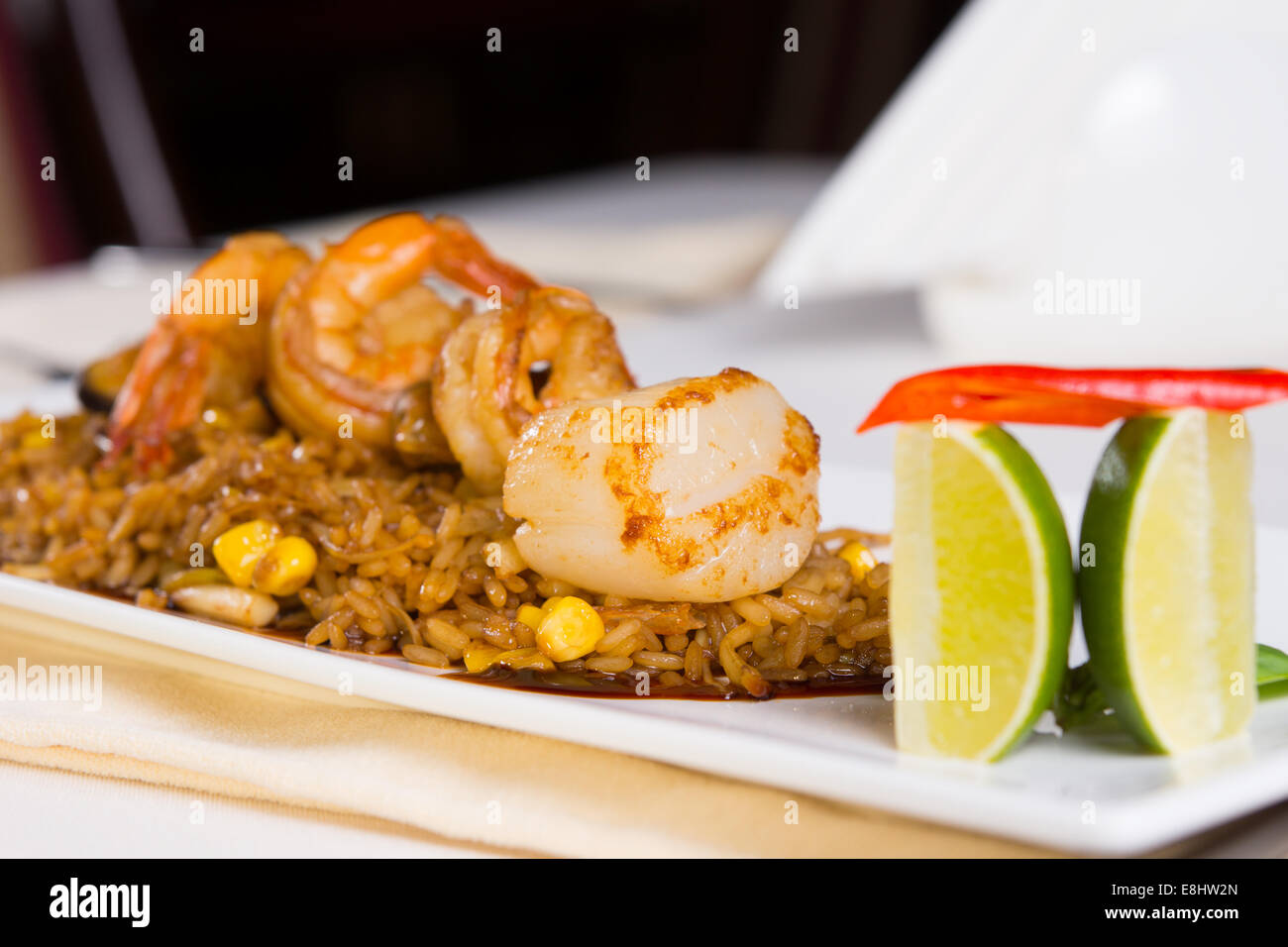 Seafood Fried Rice with Shrimp and Scallops and Garnish on Plate Stock