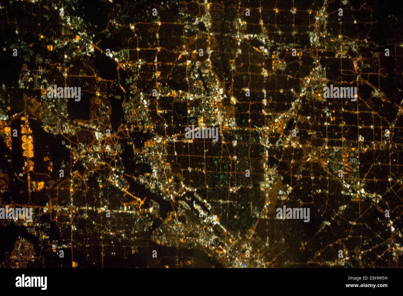 A nighttime view of the Dallas, Texas metropolitan area is featured in this image photographed by an Expedition 33 crew member o Stock Photo