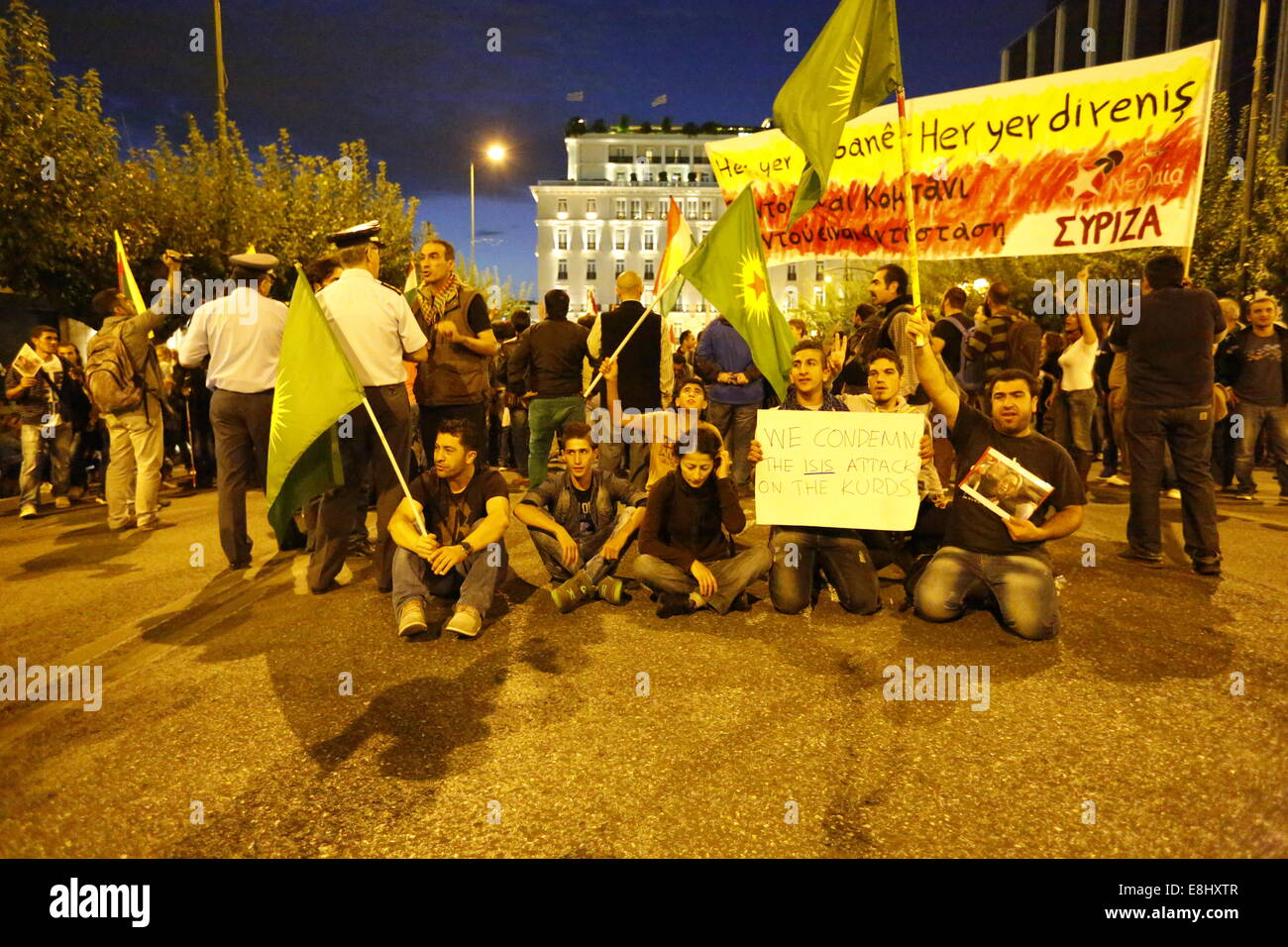 Protesters sit on the ground, posing for the cameras. Kurds living in Greece protest against the attacks of the Islamic State (IS) on the city of Kobane in Syria, calling for international support of the Kurdish fighters. They also protested against the alleged support of IS by the Turkish state. © Michael Debets/Pacific Press/Alamy Live News Stock Photo