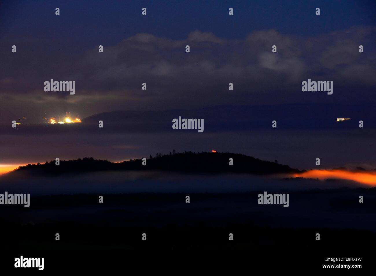 Forres, Moray, Scotland, 8th October, 2014. Hunters Moon illuminating a misty Forres and over the Moray Firth  Credit:  Steve Arkley/Alamy Live News Stock Photo