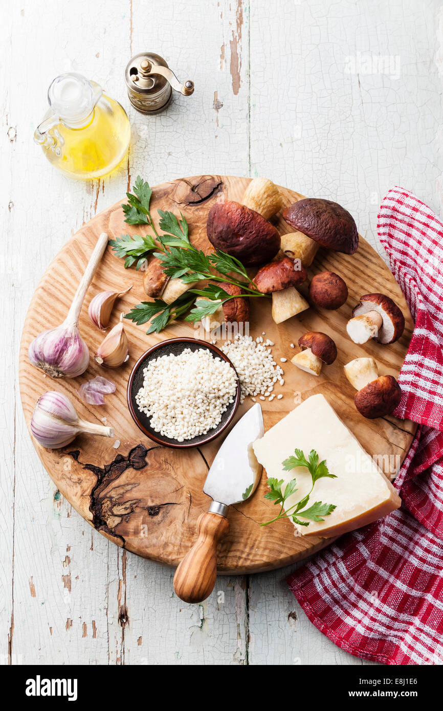 Ingredients for risotto with wild mushrooms on wooden background Stock Photo