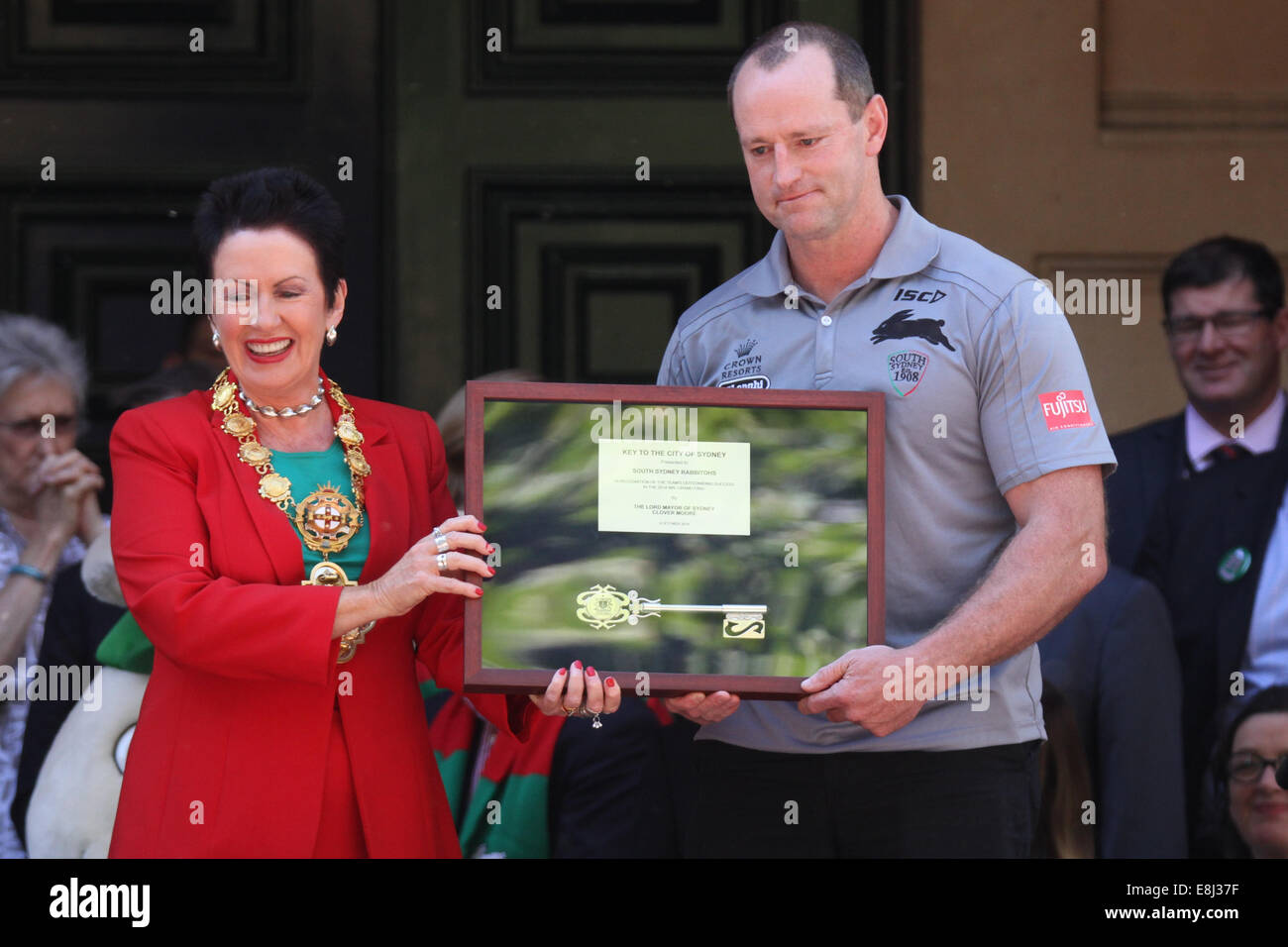 Sydney, NSW, Australia. 9th October 2014. After winning the NRL Grand Final, the South Sydney Rabbitohs were given the keys to the City of Sydney by the Lord Mayor at a ceremony in Sydney Square watched by fans of the rugby team. Pictured: Lord Mayor of Sydney Clover Moore presents South Sydney Rabbitohs Coach Michael Maguire with the keys to the City of Sydney, after the team won the NRL Grand Final. Copyright Credit:  2014 Richard Milnes/Alamy Live News. Stock Photo