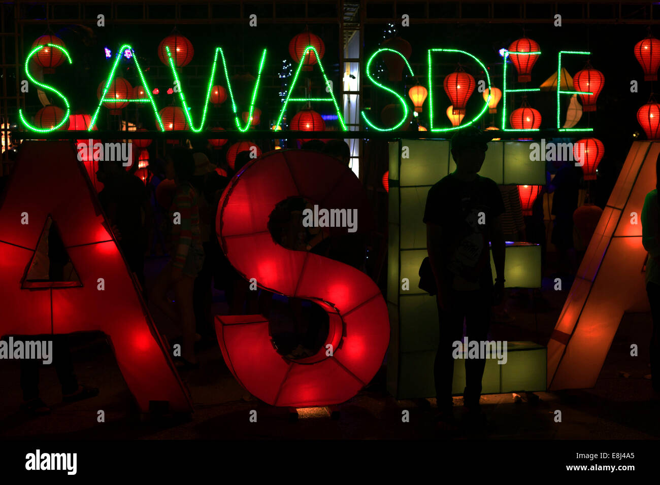 'Sawasdee' lettering in neon lights, 'welcome' to the Loi Krathong festival of lights, Thapae Gate, Chiang Mai, Thailand Stock Photo