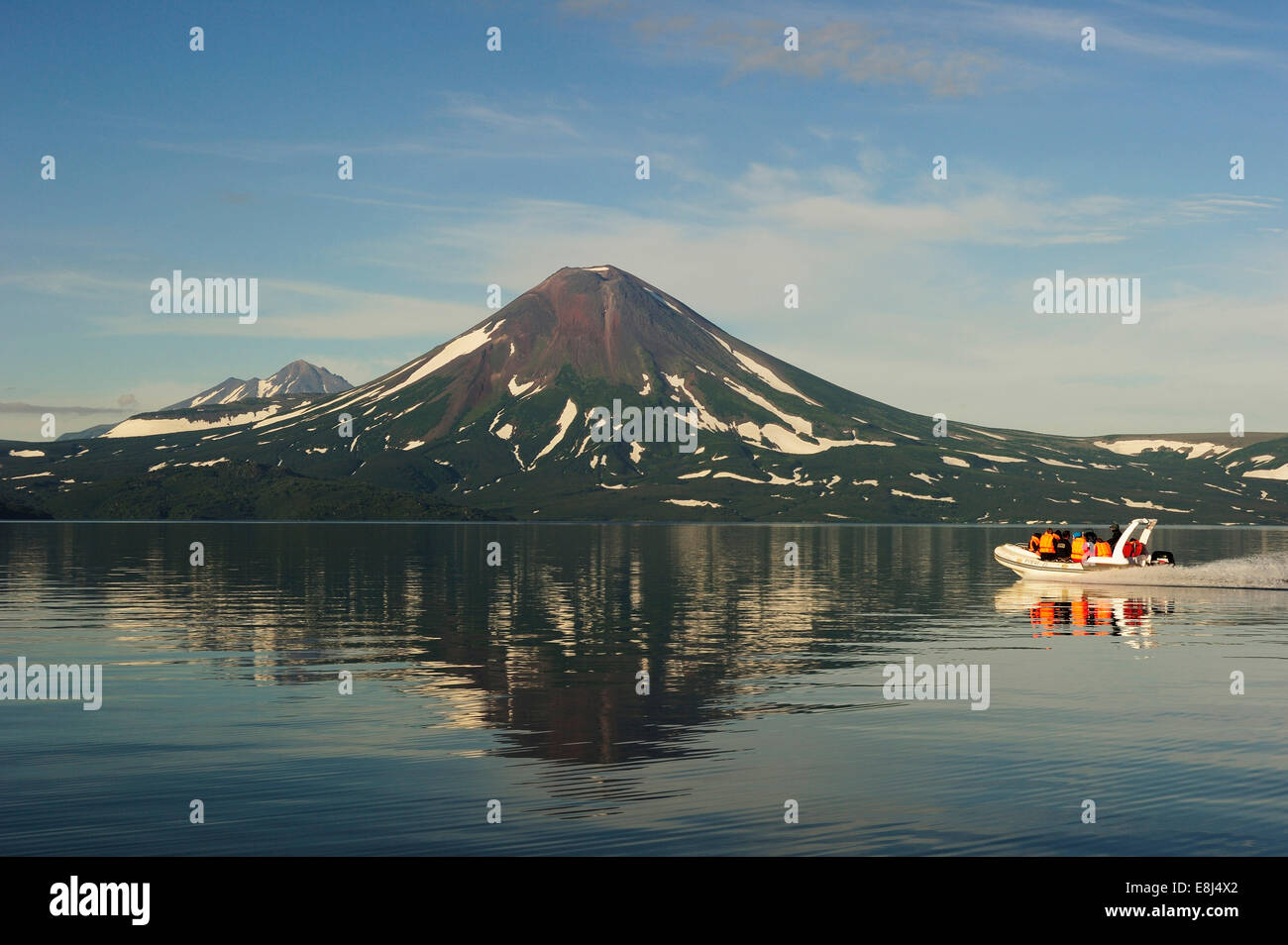 Speedboat on Kurile Lake, Ilinskaya volcano at the back, Kurilensee, Kamchatka Peninsula, Russia Stock Photo