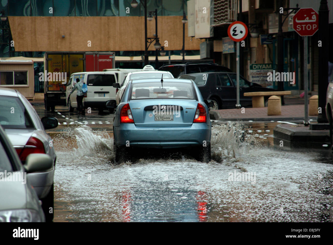 A car drives through the built-up rain water in the streets of Riyadh, Saudi Arabia Stock Photo