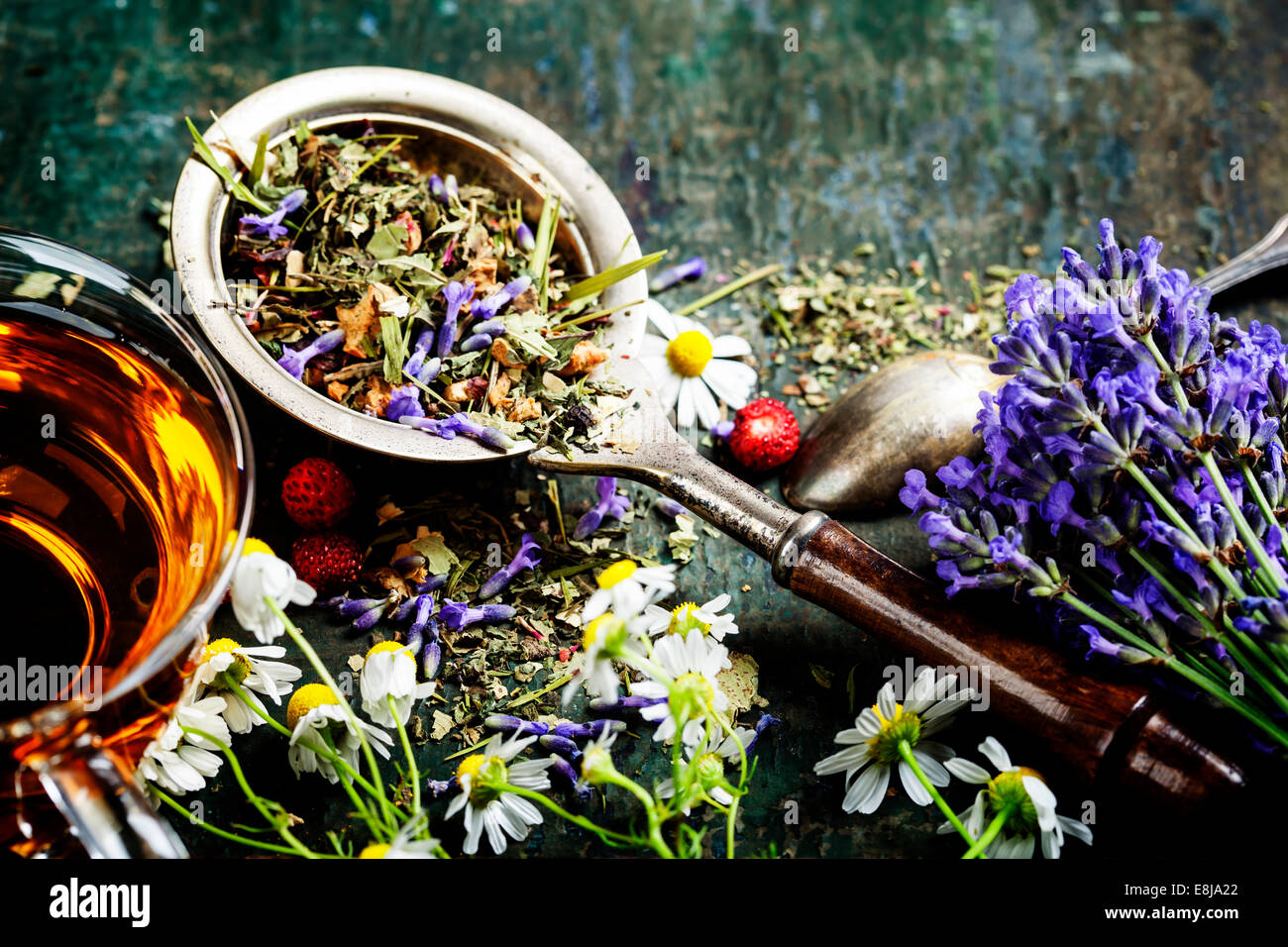 Herbal tea with wild flowers and berry on wooden background - bio food, health and diet concept Stock Photo