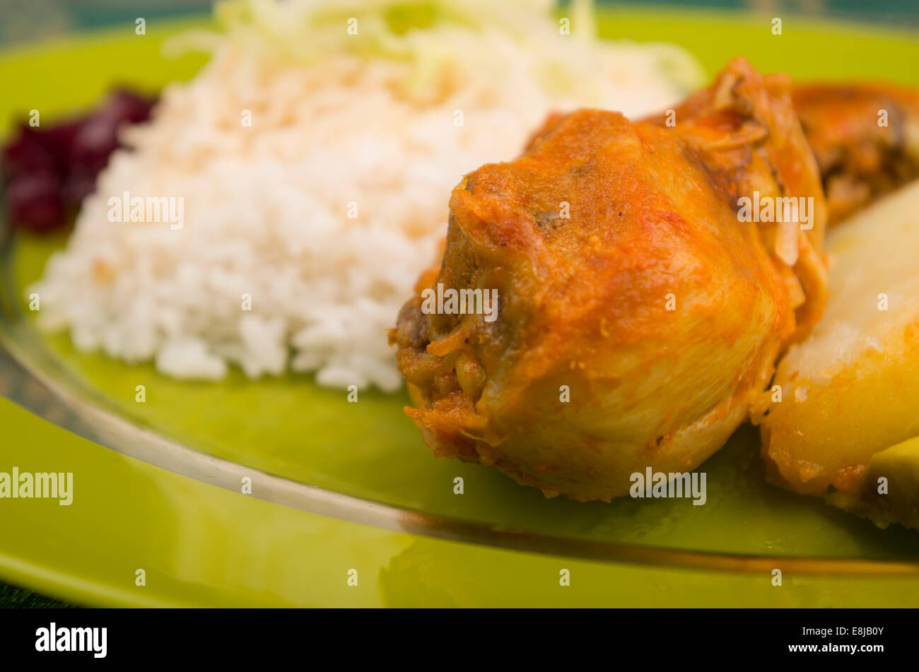 chicken served with white rice potato on a plate Stock Photo - Alamy