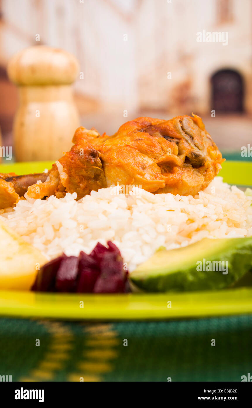 chicken served with white rice potato on a plate Stock Photo - Alamy