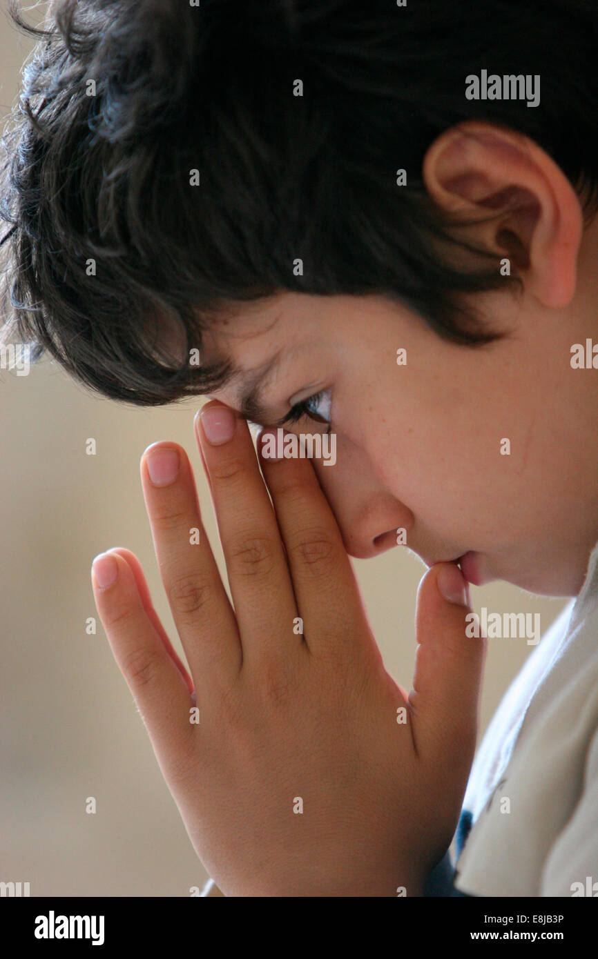 Boy praying Stock Photo