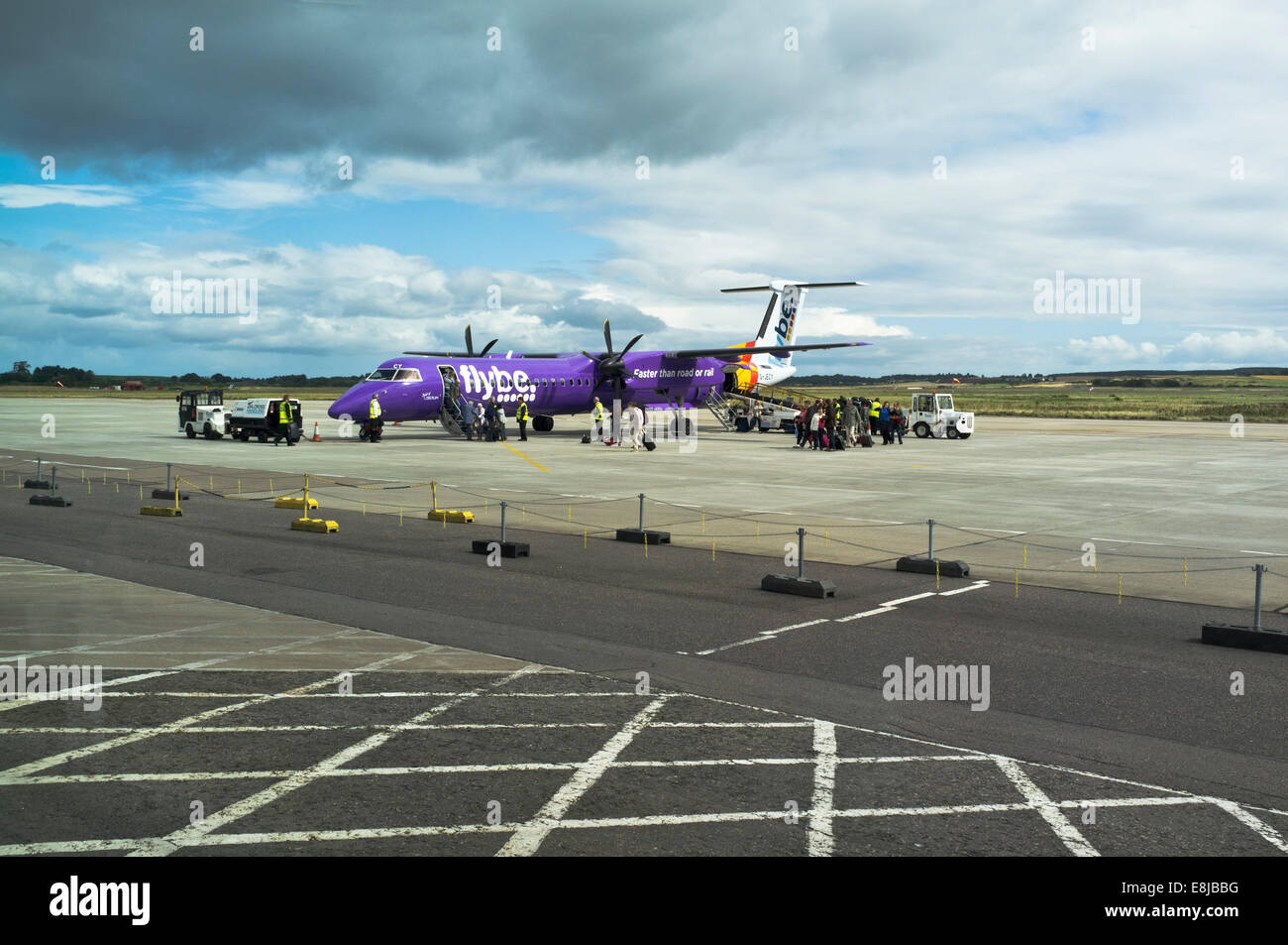 dh  INVERNESS AIRPORT INVERNESSSHIRE Flybe aircraft Internal flight discharging passengers airplane q400 dash 8 Stock Photo