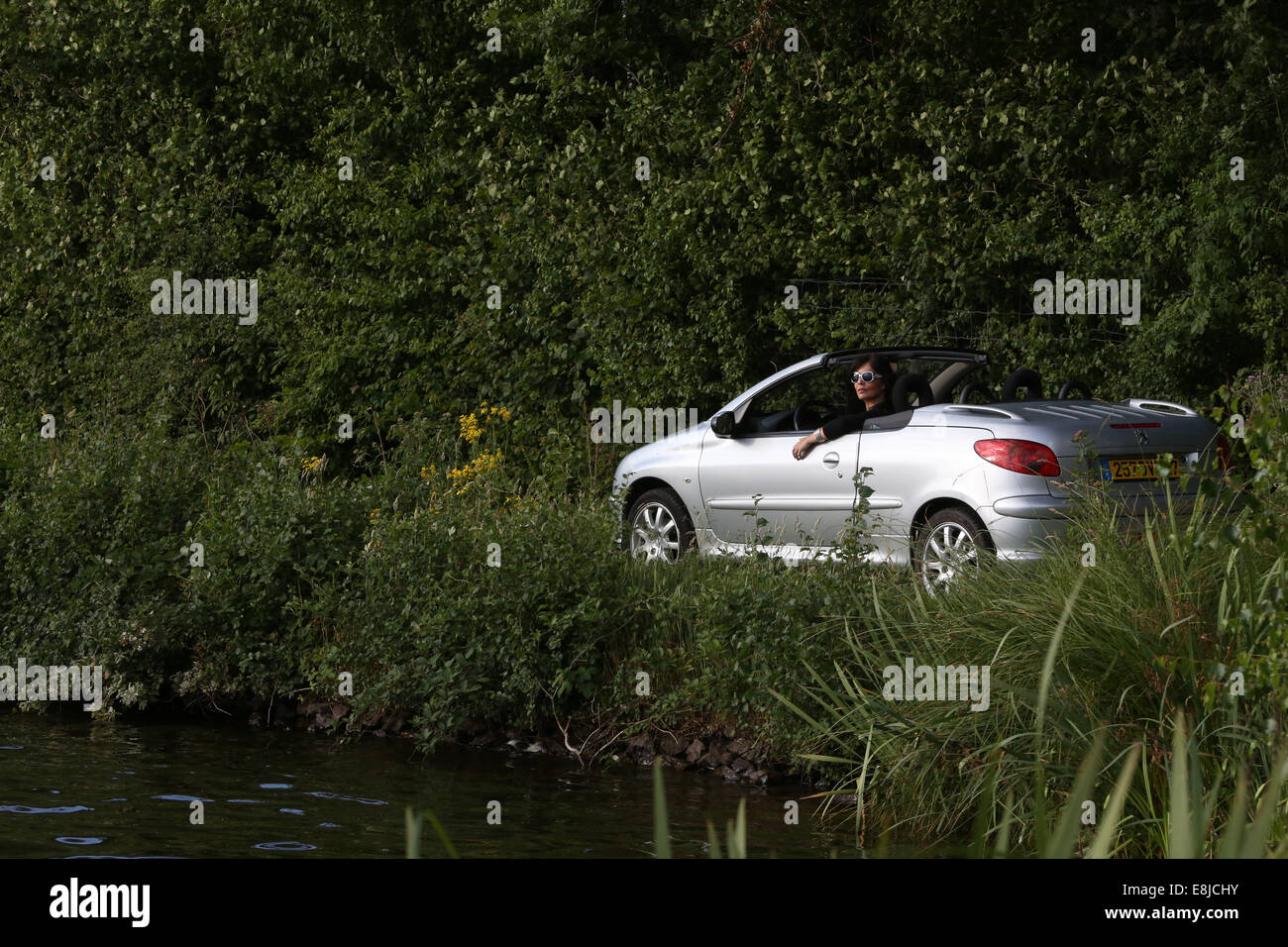 Driving a Peugeot 206 convertible. Stock Photo