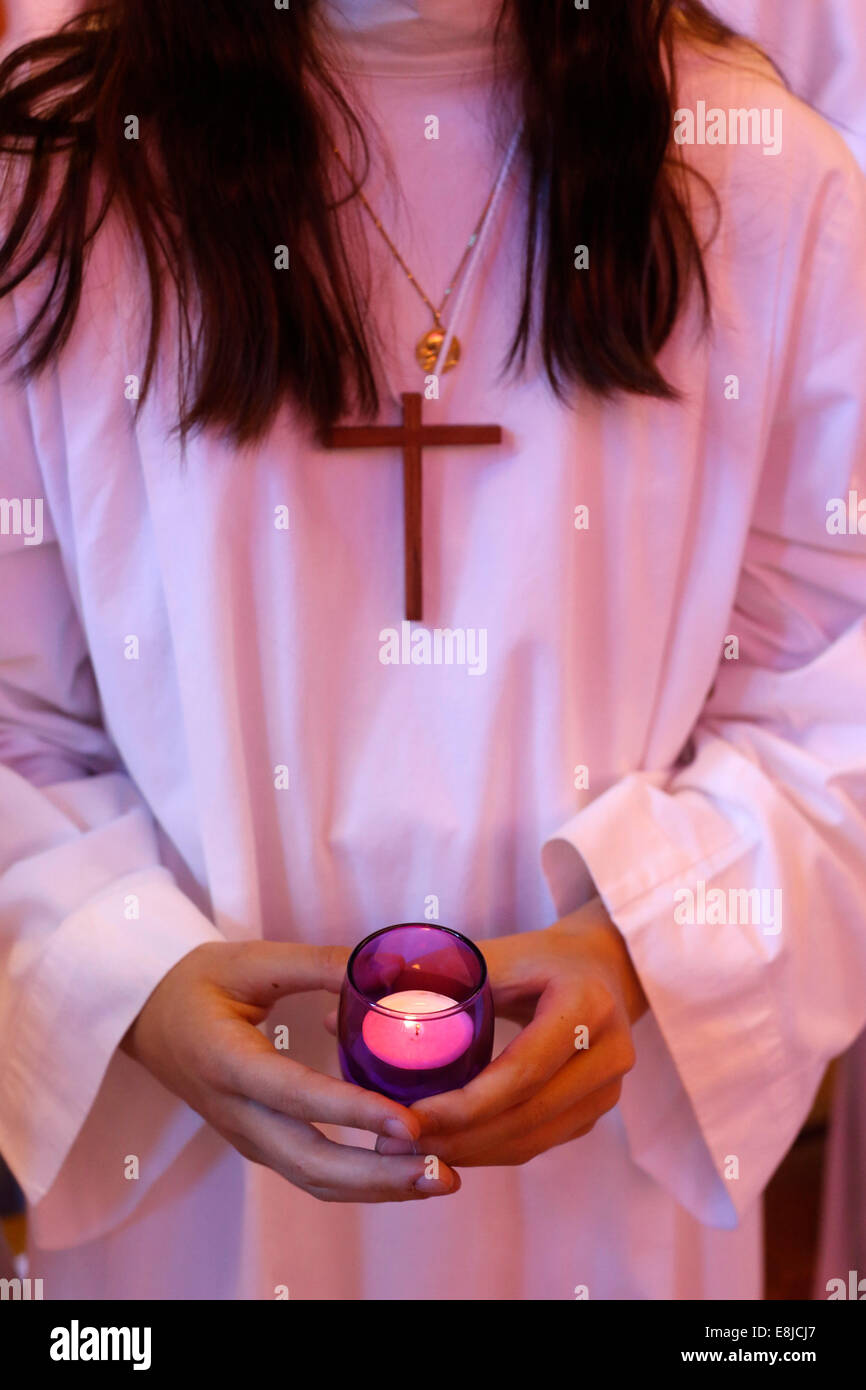 Baptism in St Jacques's catholic church child holding a candle Stock Photo Alamy