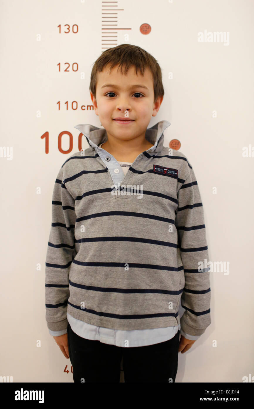 Boy measuring his height Stock Photo