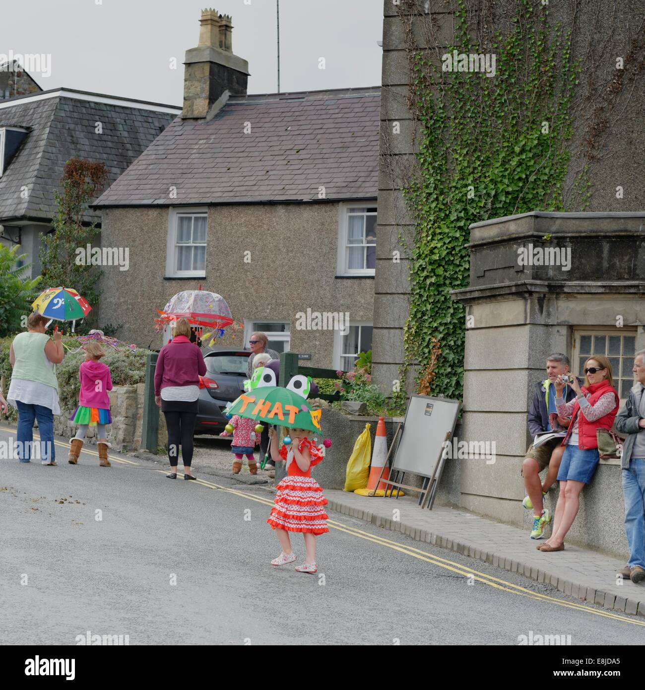 A little girl lost looking for mother during the opening procession that marks the beginning the Abersoch Jazz Festival 2014 Stock Photo
