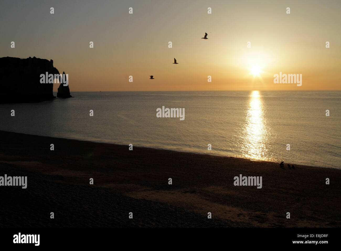 Sunset on the beach of Etretat Stock Photo - Alamy