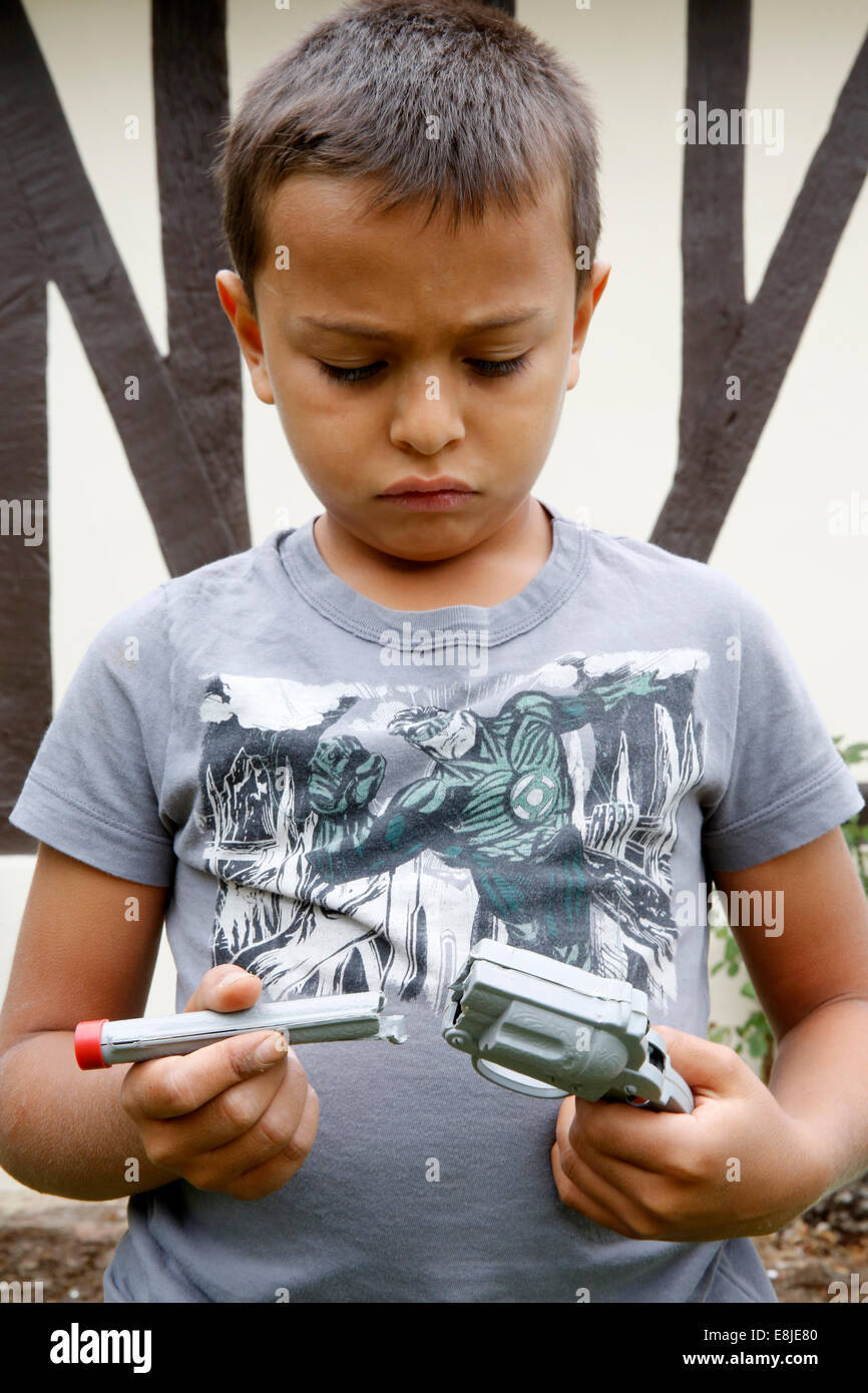 7-year-old boy holding a broken toy Stock Photo