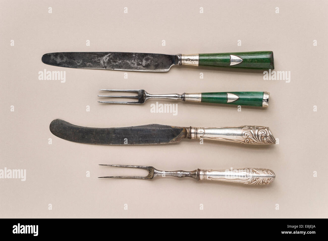 Eighteenth century English cutlery, one set with silver handles the other with green stained ivory handles. Stock Photo