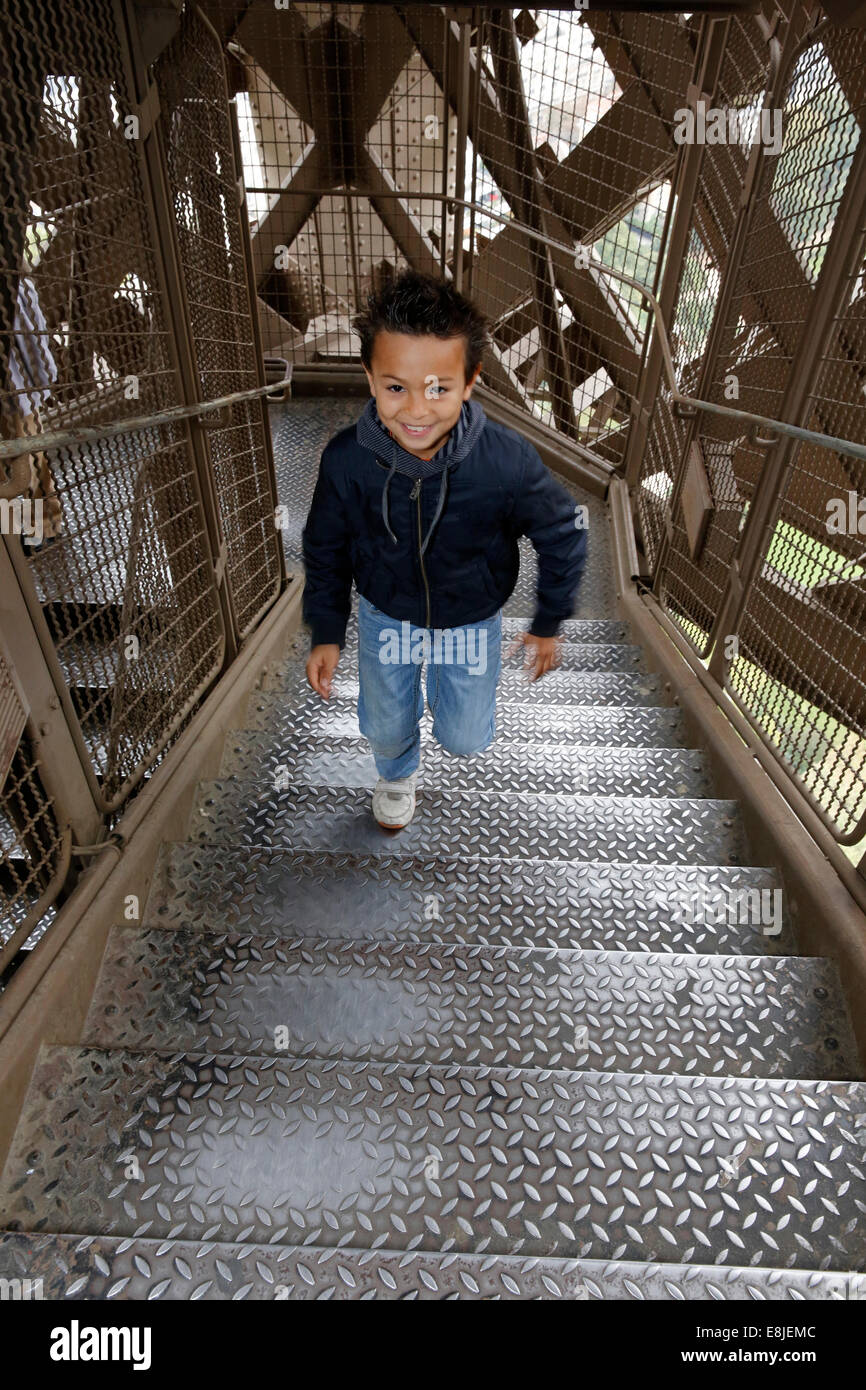 8-year-old boy going up the Eiffel tower Stock Photo