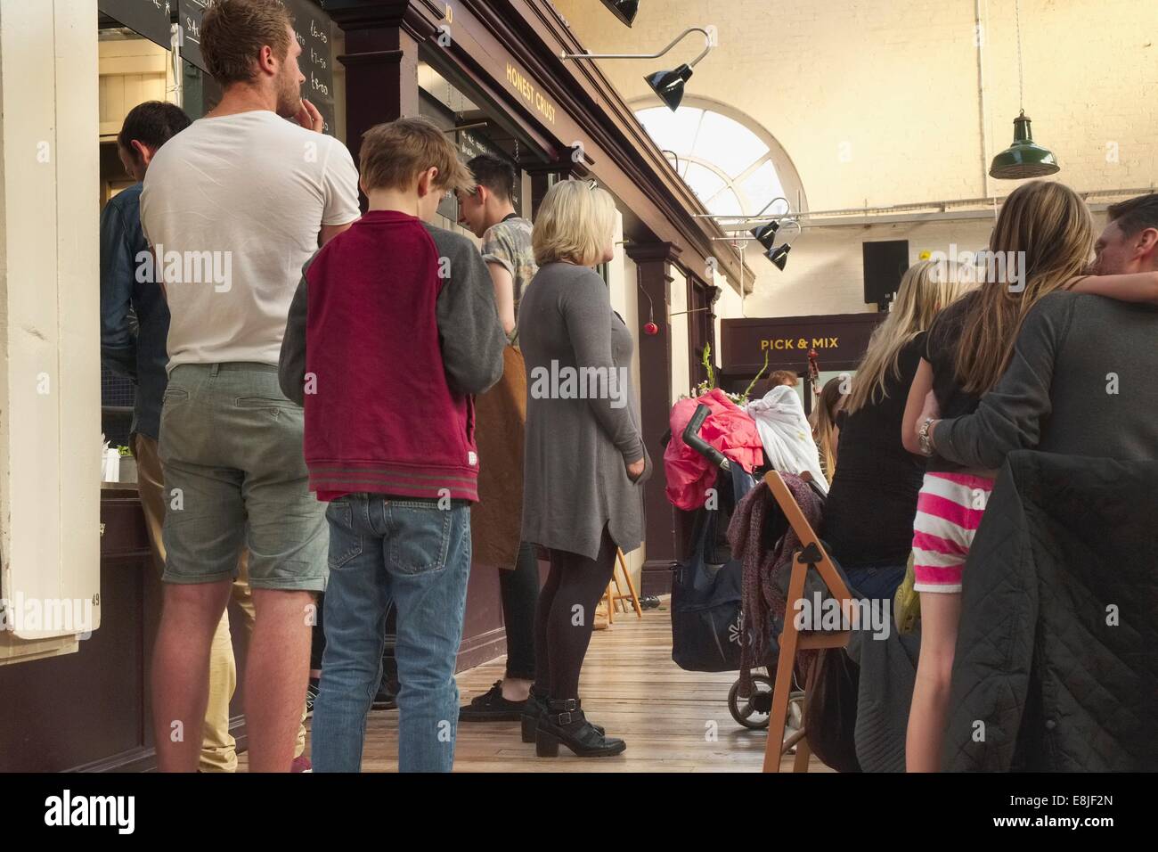 Queuing to order a freshly made pizza at the newly refurbished Victorian Altrincham Market Hall in Cheshire Stock Photo