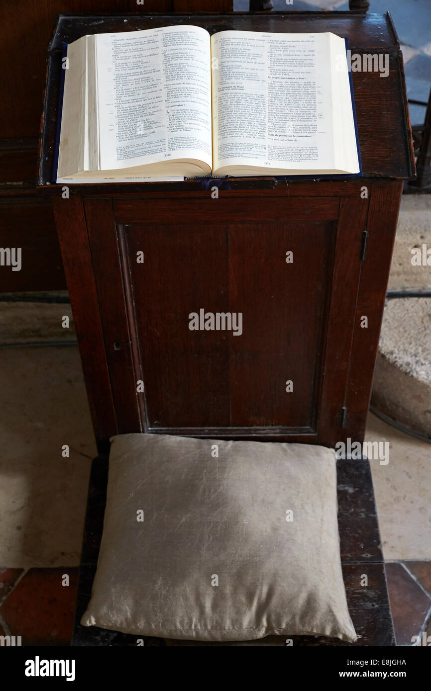 Bible laying on a prayer stool. Stock Photo