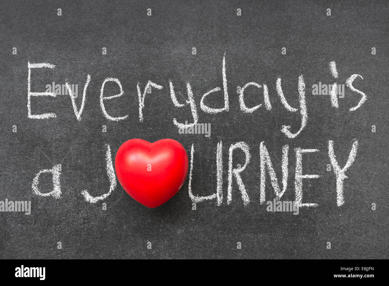 everyday is a journey phrase handwritten on chalkboard with heart symbol instead of O Stock Photo