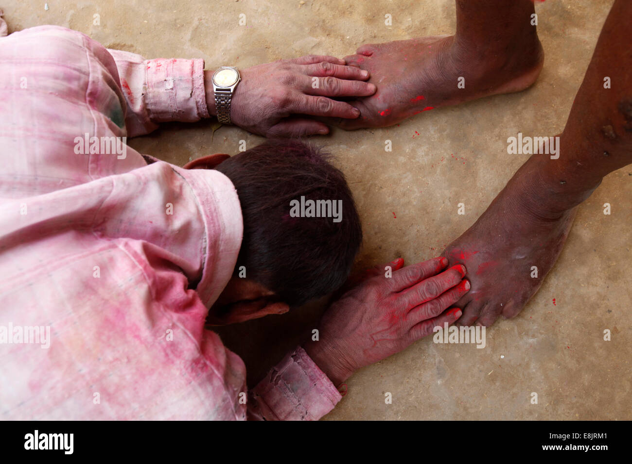 Hindu touching a holy man's feet as a sign of respect Stock Photo