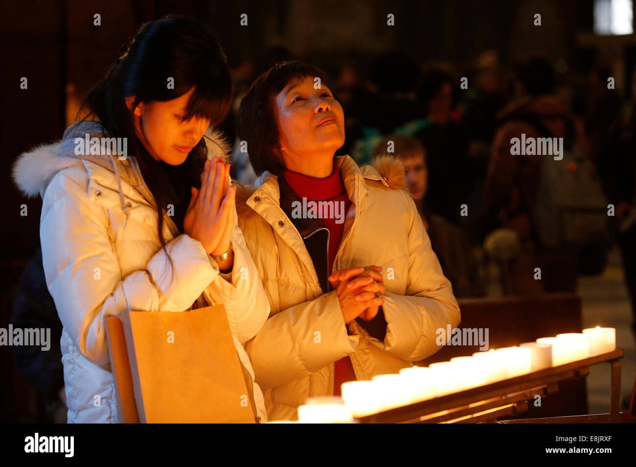 Candles church. Young Christians in a church. Stock Photo