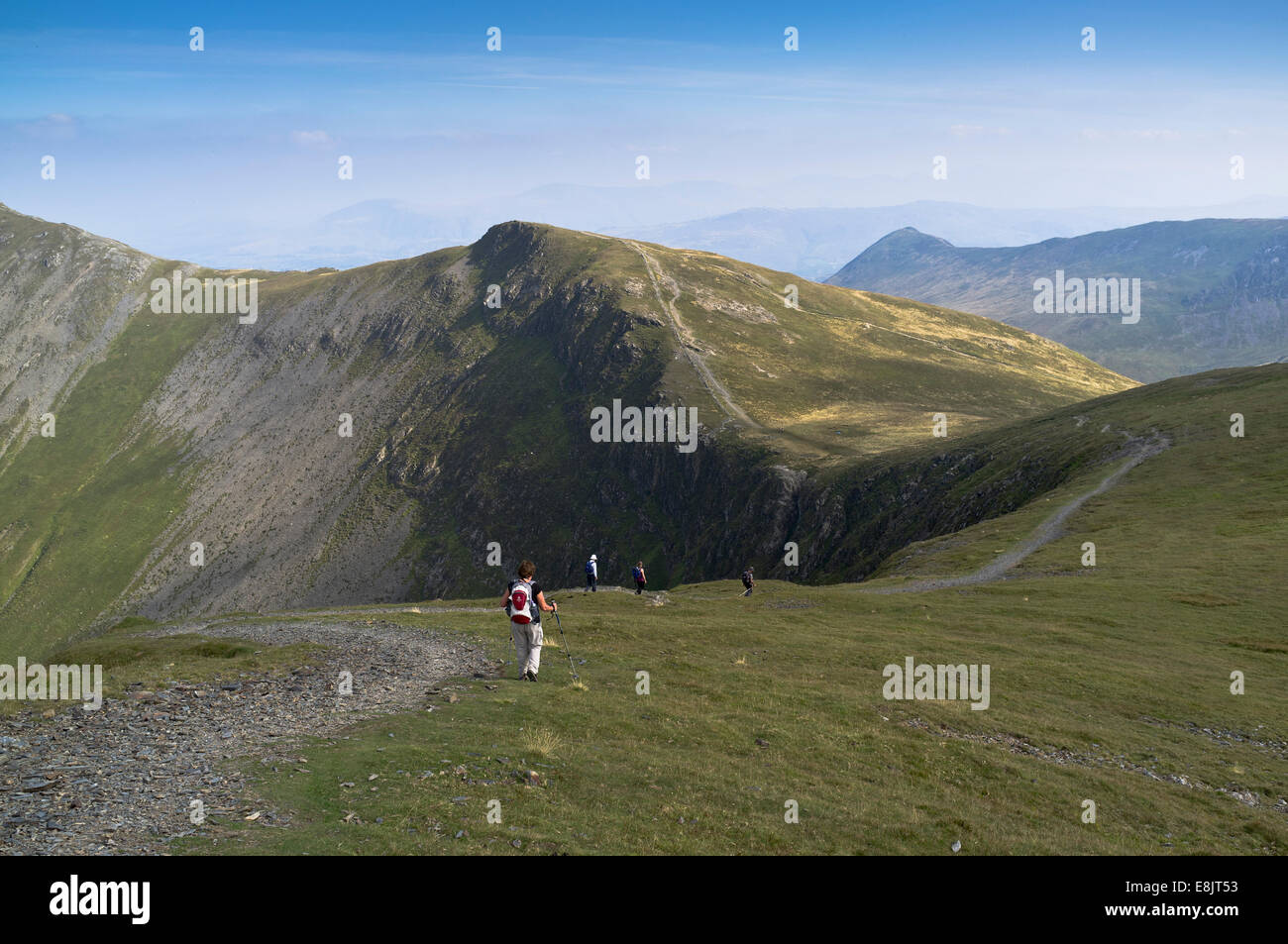 dh Lakeland fells cumbria HOBCARTON CRAG LAKE DISTRICT Hikers walking hill footpath mountains up northern hiker on a mountain walk people trekking Stock Photo
