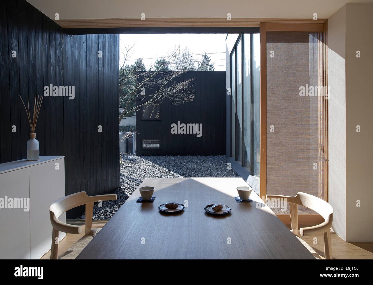 Interior of a japanese house with dining room and table facing a private garden Stock Photo