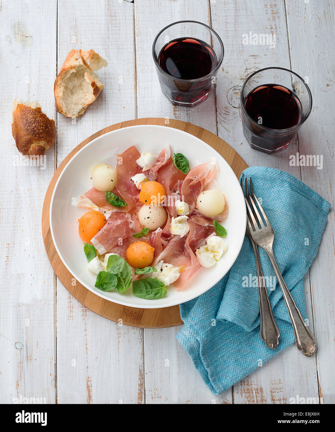Melon and prosciutto ham salad with Mozzarella Stock Photo