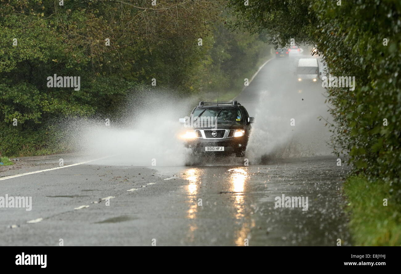 Hensol, Wales, UK. 9th October, 2014. UK Weather. A Nissan 4x4 car travels through a partially flooded country road near the village of Hensol in south Wales.  Re: Strong winds and heavy rain has been affecting parts of the UK. Credit:  D Legakis/Alamy Live News Stock Photo