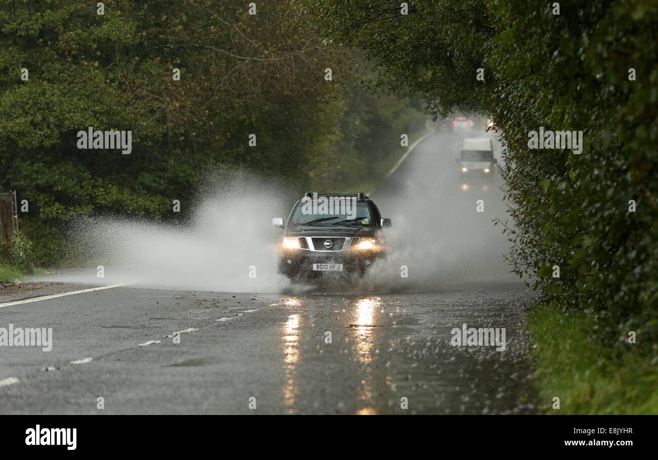 Hensol, Wales, UK. 9th October, 2014. UK Weather. A Nissan 4x4 car travels through a partially flooded country road near the village of Hensol in south Wales.  Re: Strong winds and heavy rain has been affecting parts of the UK. Credit:  D Legakis/Alamy Live News Stock Photo