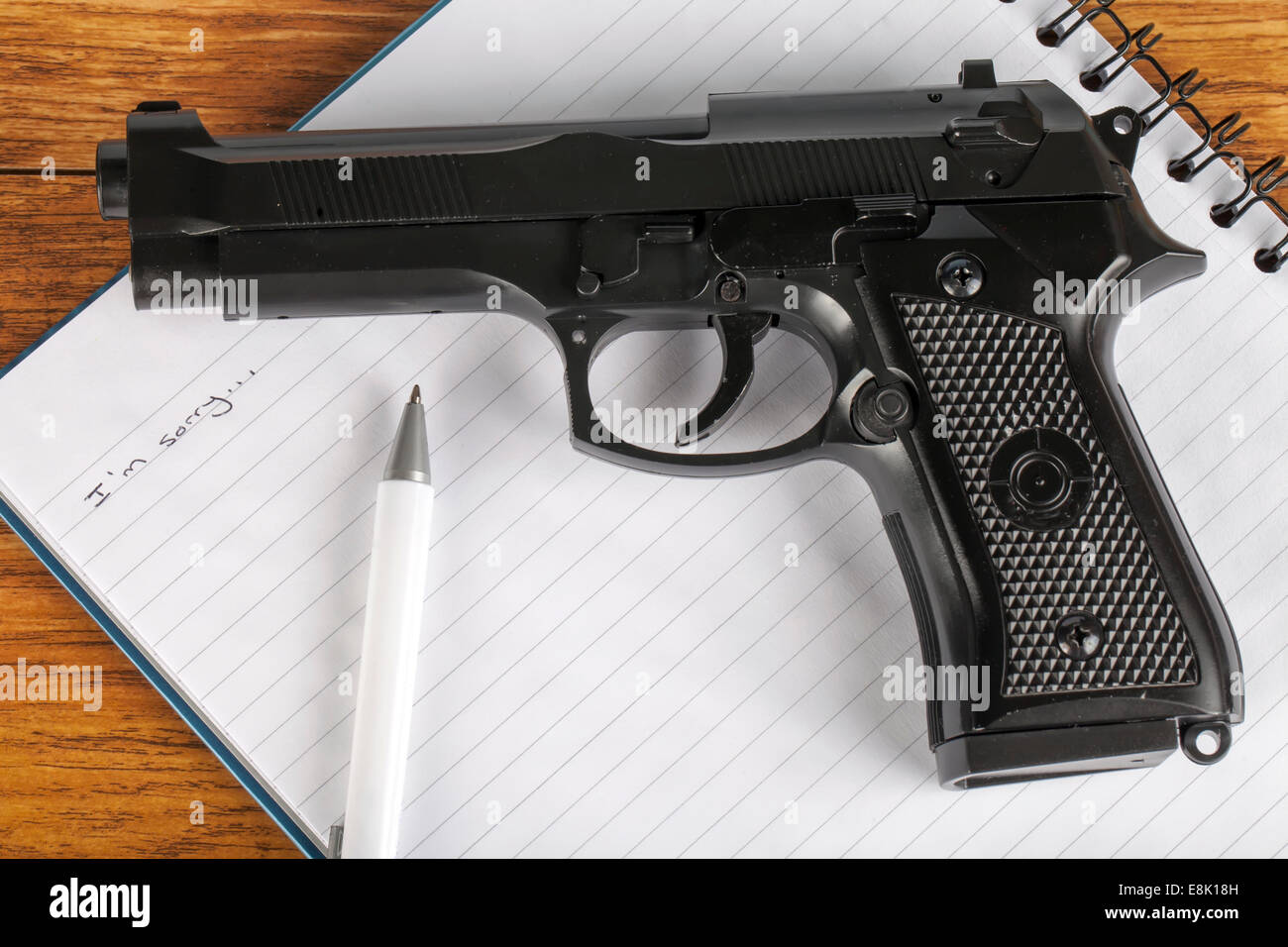 Concept of suicide note with gun Stock Photo