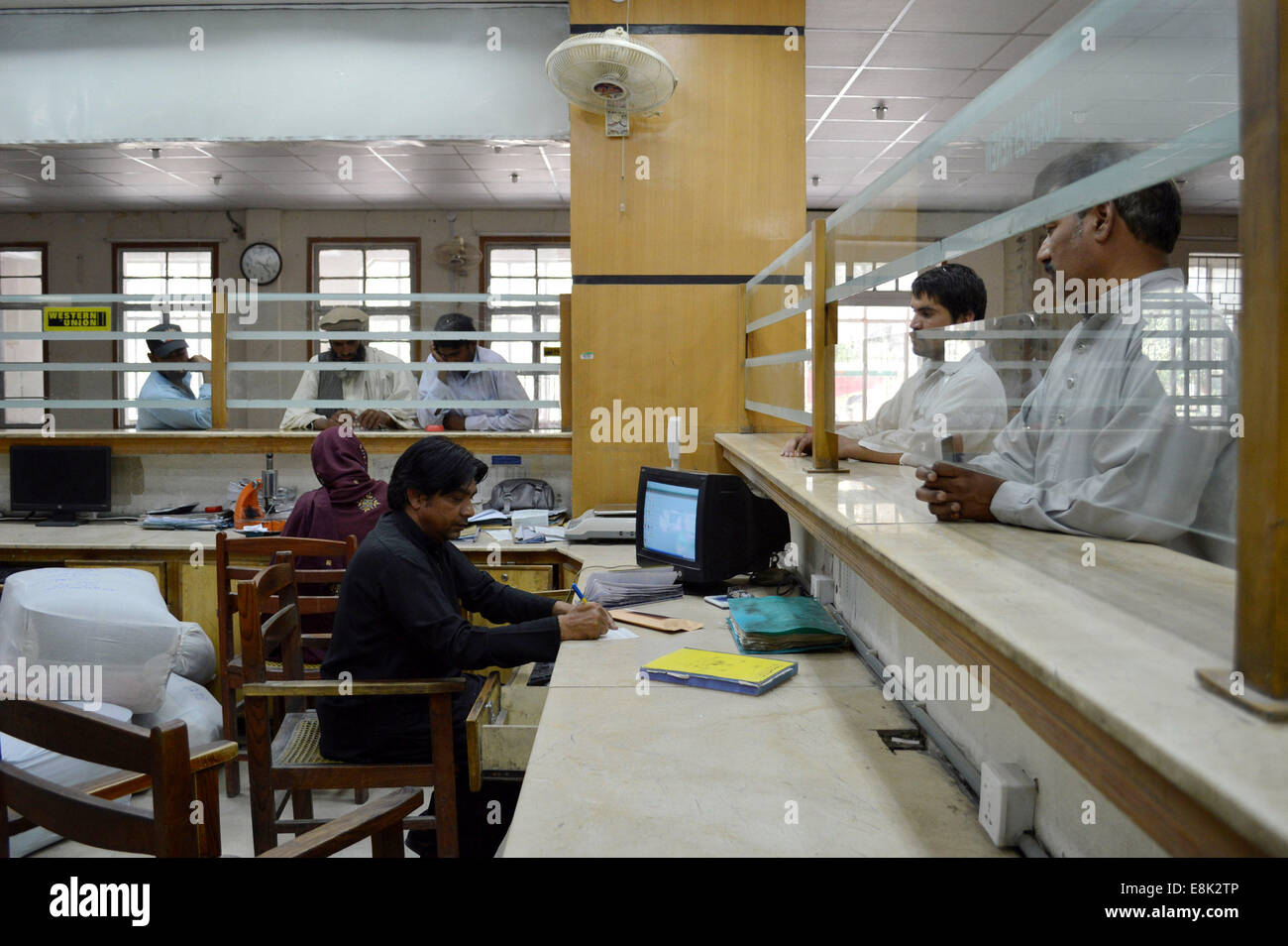 Quetta. 9th Oct, 2014. Pakistani post office employees work on the