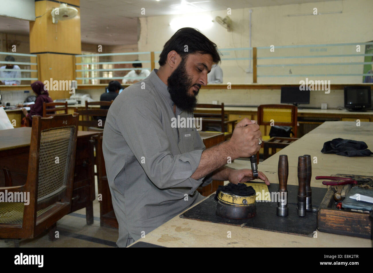 Quetta. 9th Oct, 2014. A Pakistani post office employee stamps a mail on the World Post Day in southwest Pakistan's Quetta on Oct. 9, 2014. World Post Day is celebrated each year on Oct. 9, the anniversary of the establishment of the Universal Postal Union (UPU) in 1874 in the Swiss capital, Berne. It was declared World Post Day by the UPU Congress held in Tokyo, Japan, in 1969. Credit:  Irfan/Xinhua/Alamy Live News Stock Photo