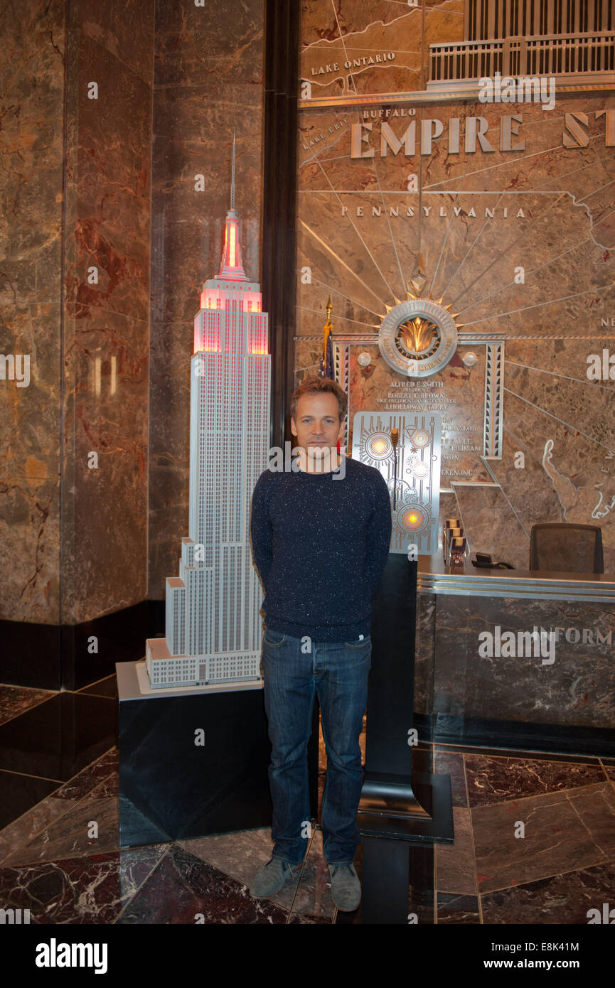 Manhattan, New York, USA. 9th Oct, 2014. Peter Sarsgaard  lights The Empire State Building in red to celebrate the 10th Anniversary of The Rubin Museum of Art, Thursday, Oct. 9, 2014. Credit:  Bryan Smith/ZUMA Wire/Alamy Live News Stock Photo