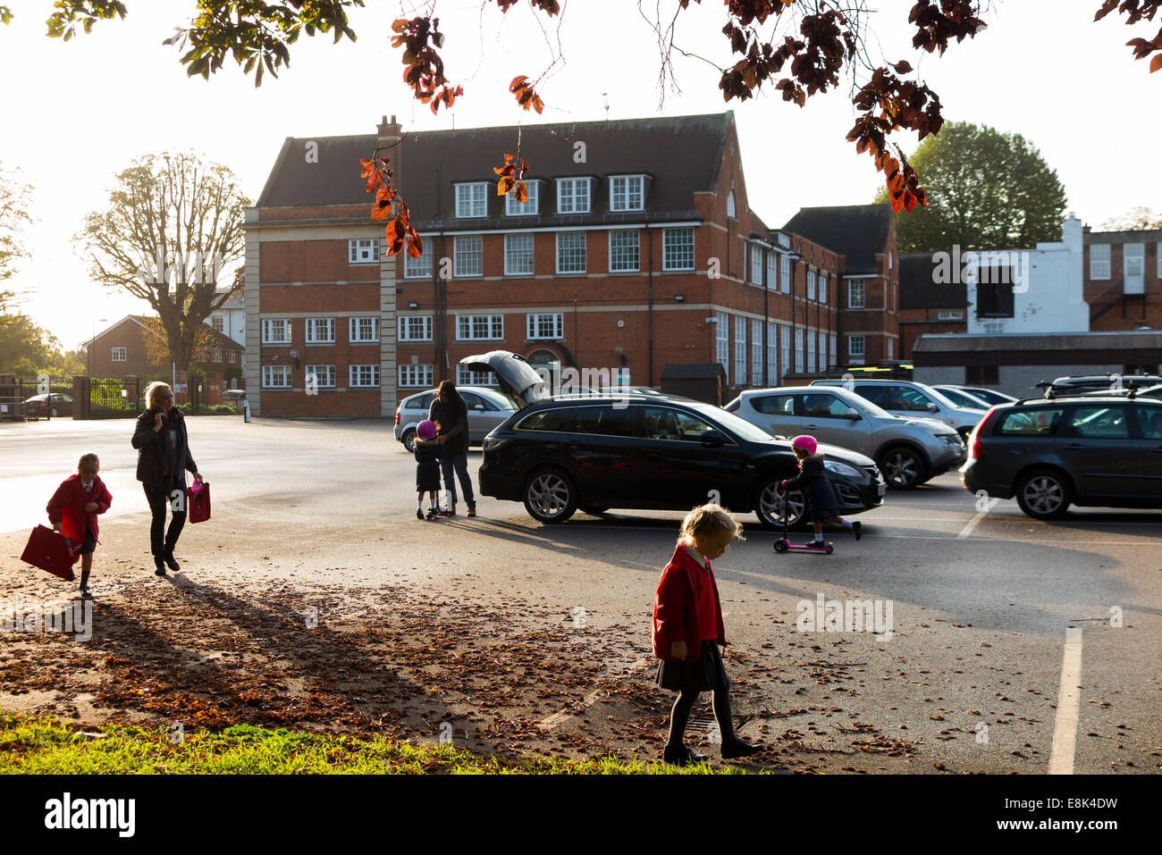School car park during term time / cars parking in the morning drop off at a primary and secondary school. UK. Stock Photo